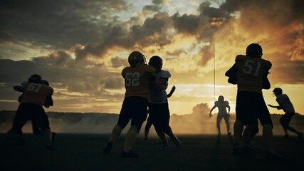 Wall Mural - American Football Field Two Teams Compete: Players Pass and Run Attacking to Score Touchdown Points. Professional Athletes Fight for the Ball, Tackle. Cinematic Slow Motion, Golden Hour Sunset