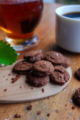 Sticker - Vertical shot of chocolate cookies with a cup of coffee and tea on the table