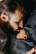 © Ananass - Silhouette of a stylish bearded father kisses a sleeping newborn girl. Parent holding rocking child daughter son in hands. Authentic lifestyle parenting fatherhood moment. Single dad family home life.