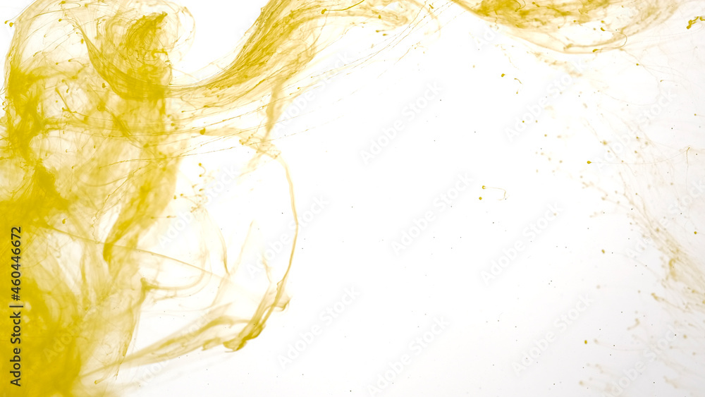 Yellow watercolor ink in water on a white background. Colored acrylic ...