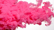 Pink cloud of ink on a white background. Awesome abstract background. Drops of pink ink in water. Pink watercolor ink in water on a white background.