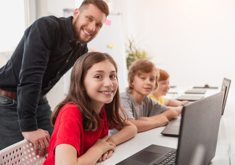 Wall Mural - smart kids studying programming in classroom