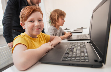Wall Mural - mother and son using laptop on bed