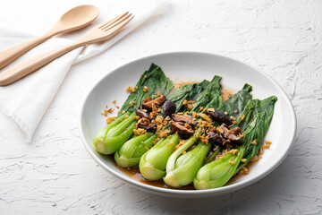 Baby Bok choy or chinese cabbage in oyster sauce with Shitake Mushrooms and fried garlic.