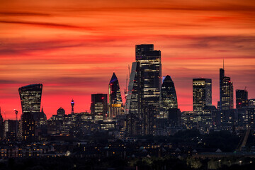 Wall Mural - The modern skyline of the financial district City of London, United Kingdom, during evening time with a colorful sky