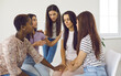 © Studio Romantic - Interracial group of young women comforting a sad depressed friend, talking about her problems, supporting her, giving some advice and helping cope with a difficult situation in her life
