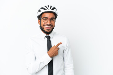 Sticker - Young business latin man holding a bike helmet isolated on white background pointing to the side to present a product