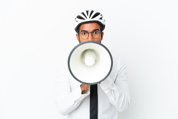 Sticker - Young business latin man holding a bike helmet isolated on white background shouting through a megaphone