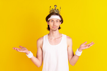 Sticker - Portrait of attractive sportive cool guy wearing golden crown isolated over bright yellow color background