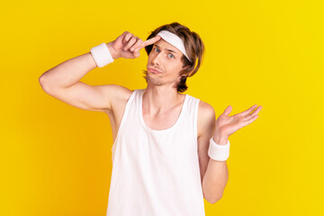 Sticker - Portrait of attractive cheery sportive clueless guy fixing headband isolated over bright yellow color background