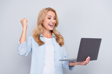 Sticker - Photo of cheerful beautiful businesswoman raise fist in victory successful contract project isolated on grey color background