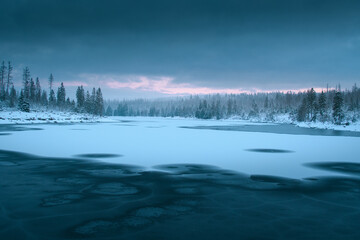 Wall Mural - Wonderful natural morning scene of a frozen lake in the white winter mountains with dramatic clouds and weather. Oderteich, Harz Mountains National Park in Germany