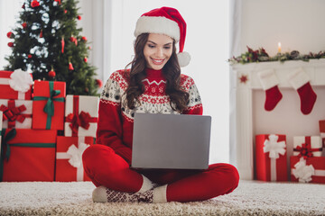 Canvas Print - Full length body size photo smiling woman sitting on floor in headwear using laptop