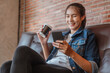 © Garun Studios - Women hold coffee cup is relax to the watching or shopping on labtop during coffe break after work outside at coffee shop in sunset.