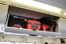 Cabin luggage inside overhead stowage compartment of an airplane