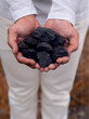 Man holding coal in hands