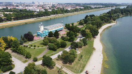 Poster - Deep river in greenery near the city