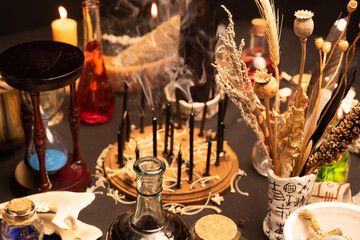 Wall Mural - Witchcraft still life with witch weeds selective focus at front. Esoteric gothic and occult witch table for Halloween. Various magic objects and ritual arrangement with symbols. Gothic Halloween.