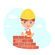 Kid builder working on building construction, cute worker boy in helmet holding trowel