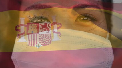 Wall Mural - Animation of flag of spain waving over woman wearing face mask during covid 19 pandemic