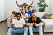 © Krakenimages.com - Group of young friends smiling happy playing video game at home.