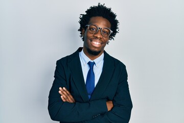 Poster - Young african american man wearing business suit happy face smiling with crossed arms looking at the camera. positive person.