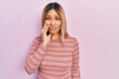 © Krakenimages.com - Beautiful hispanic woman wearing casual striped sweater touching mouth with hand with painful expression because of toothache or dental illness on teeth. dentist