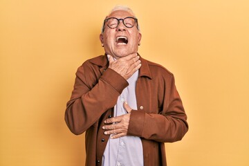 Wall Mural - Senior man with grey hair wearing casual jacket and glasses shouting and suffocate because painful strangle. health problem. asphyxiate and suicide concept.