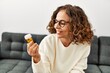 © Krakenimages.com - Middle age hispanic woman smiling confident holding pills at home