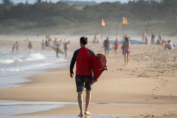 Sticker - surfer from behind walking on the beach