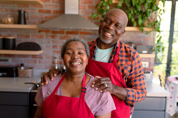 Portrait of happy african american senior couple in kitchen