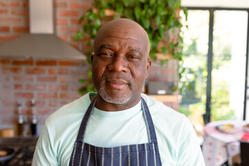 Portrait of serious african american senior man in kitchen