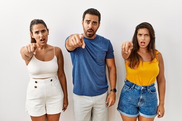 Poster - Group of young hispanic people standing over isolated background pointing displeased and frustrated to the camera, angry and furious with you