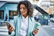 © Krakenimages.com - Young hispanic business woman wearing professional look smiling confident at the city using smartphone