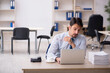 © Elnur - Young male employee unhappy with excessive work in the office