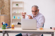 © Elnur - Old male dentist in telemedicine concept