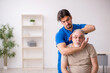 © Elnur - Old male patient visting young male doctor chiropractor