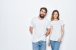 © SHOTPRIME STUDIO - Cheerful man and woman in white t-shirts and jeans design studio light background
