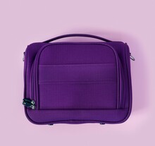 Beautiful Textile Purple Travel Bag On  Pink Paper Background  In Zine Style.