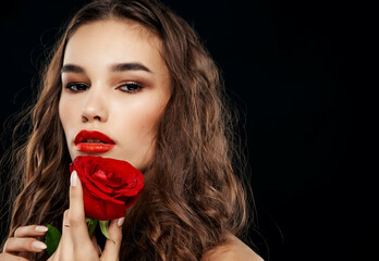 Wall Mural - attractive woman naked shoulders red rose dark background