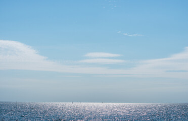 Wall Mural - thin decorative clouds over the lake - sunlight effect