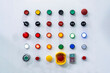 © Surasak - Various electric power control push button switch and status lamp select on off emergency switch and other for industrial machine install on cabinet