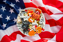 Candy Bowl Of Cookies, Candy, Chocolates And Sweets On American Flag,  Halloween Jack O Lantern - Trick Or Treat Halloween Card Orange Background