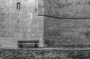 Sticker - Monochrome shot of an old empty bench by the wall