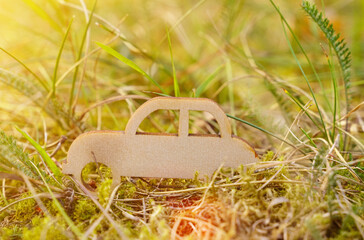 A wooden car is standing in the green grass.