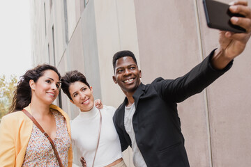 group of african and caucasian friends in their 40s taking a picture