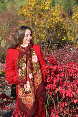 Wall Mural - Russian tourist girl in vintage Pavlovo Posad shawl, Pavloposadsky scarf. Autumn garden in Russia. Russian traditional national folk folk style in fashion. Autumn. Fall look. Red shawl, scarf