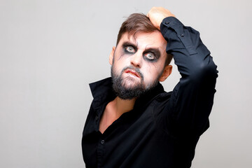 Wall Mural - halloween and makeup for a bearded man who tears the hair on his head