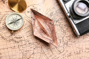 Canvas Print - Paper boat, compass, photo camera and world map, closeup