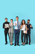 © Pixel-Shot - Team of young business people showing thumb-up on blue background